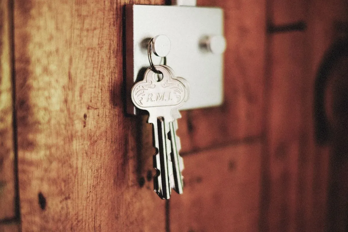 Keys hanging on a hook on a wooden wall