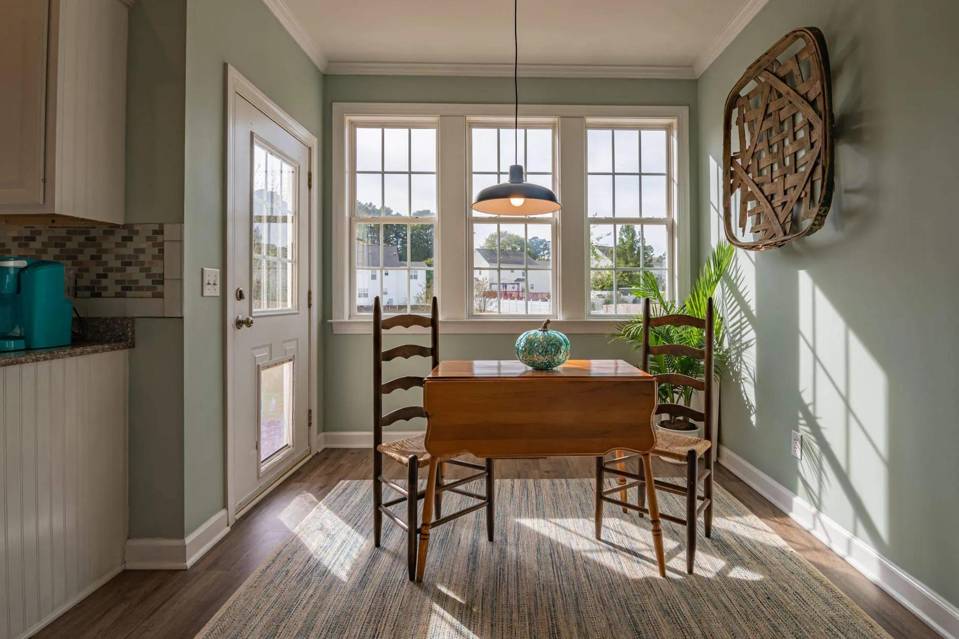A dining room table by a bright window