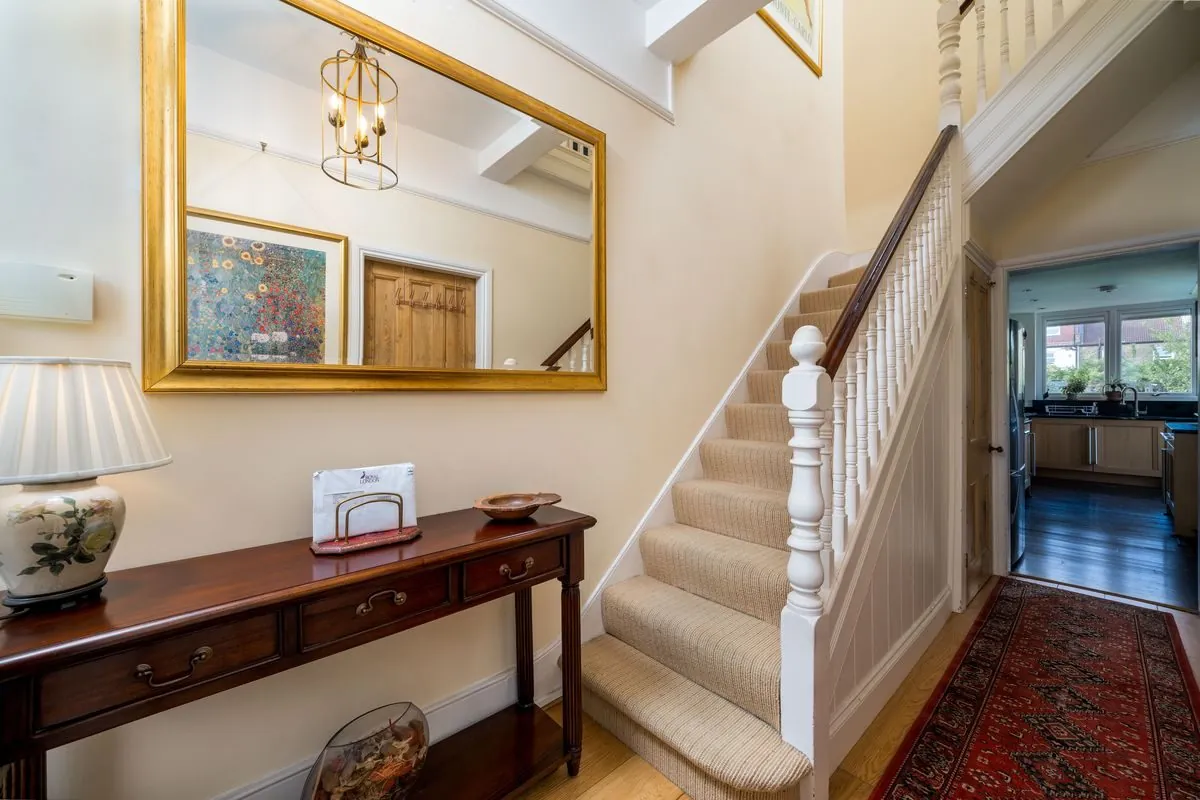 A staircase and hall table in an older house